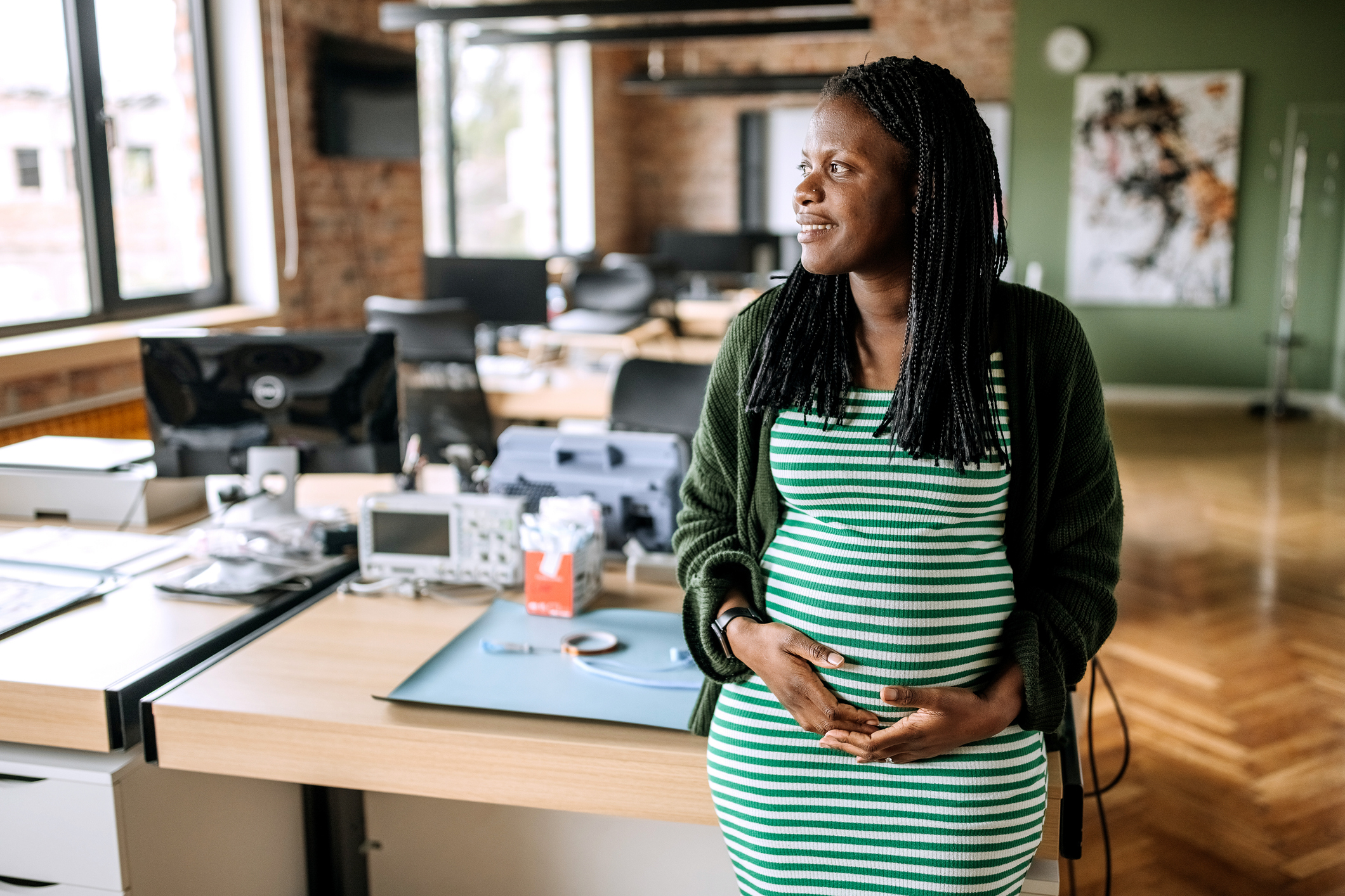 Pregnant businesswoman posing in the office